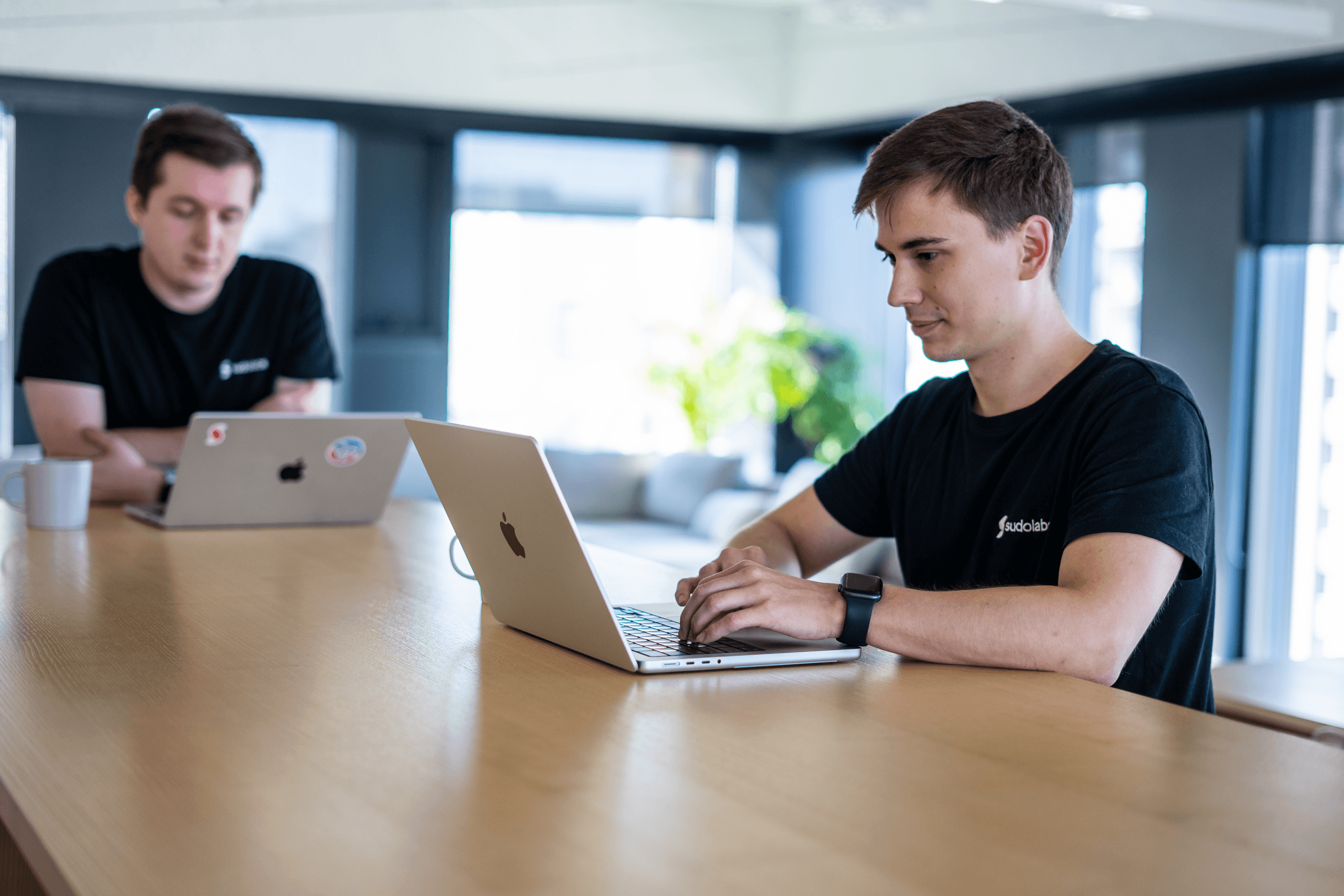 Erik Kandalík and Tomáš Kuchárik, data scientists, engaged in a collaborative work session in our kitchen's common area