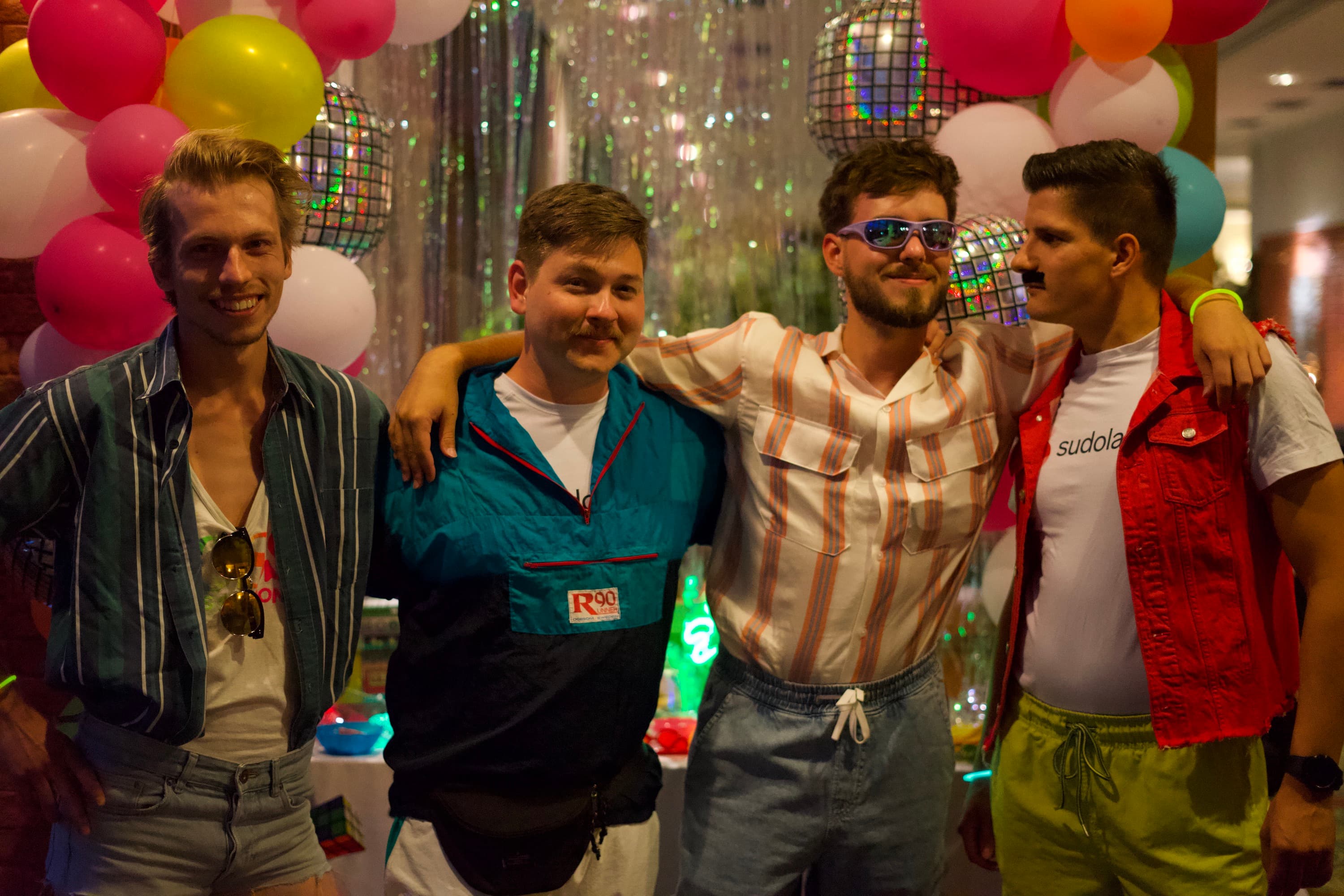 Richard, Ivan, Jozef and Jozi posing for a picture in 80s style clothes