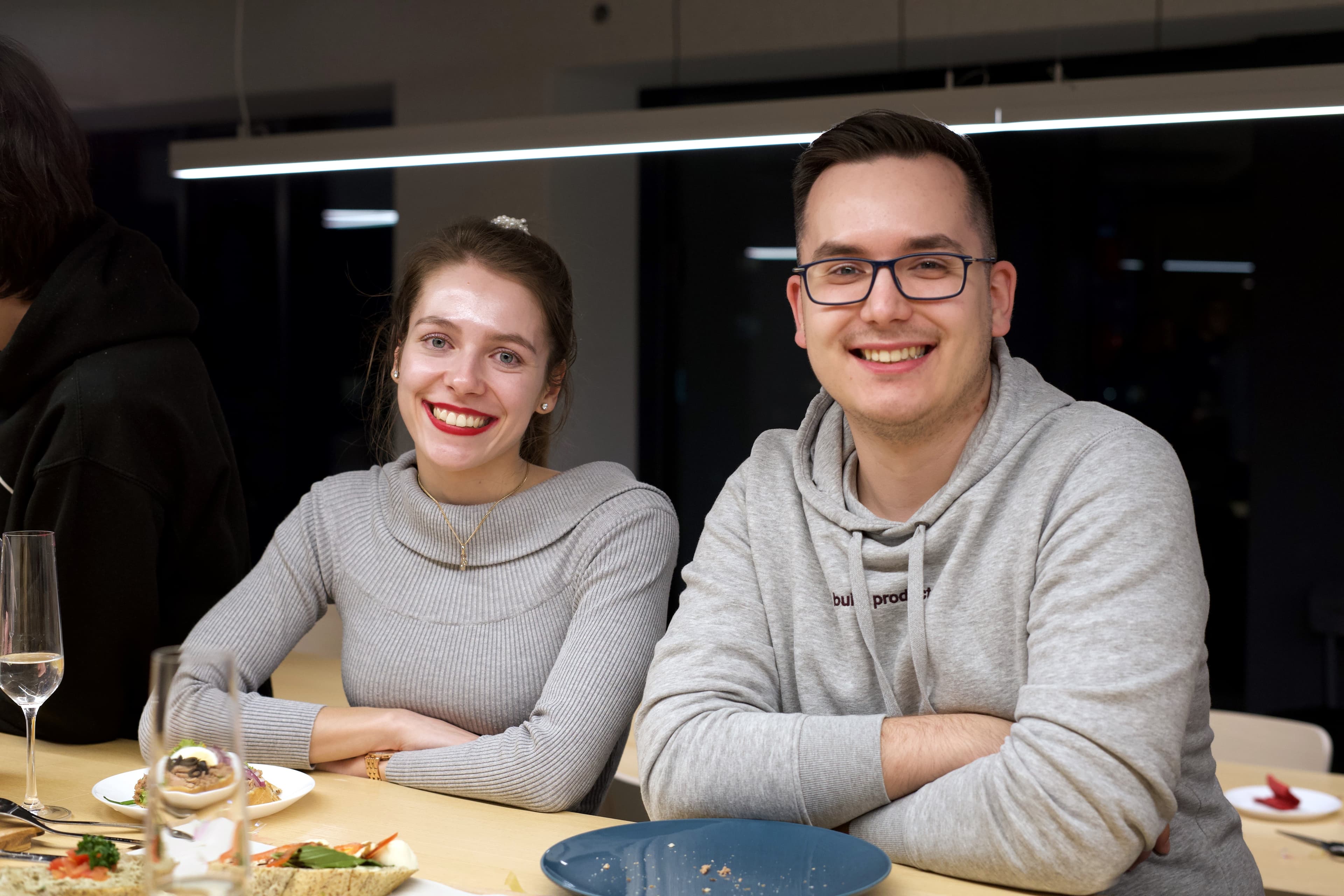 Žaneta and Martin smiling at the camera enjoying good food and drinks at the Sudolabs' anniversary party