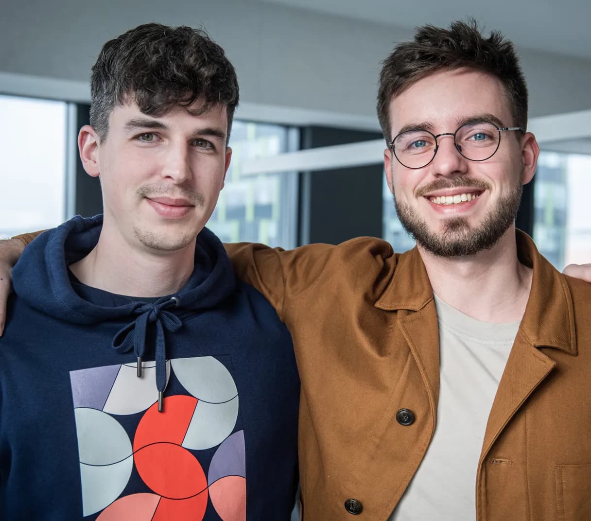 Sudolabs CEO Jozef Petro and CTO Pavol Madar holding each other around the arms and smiling