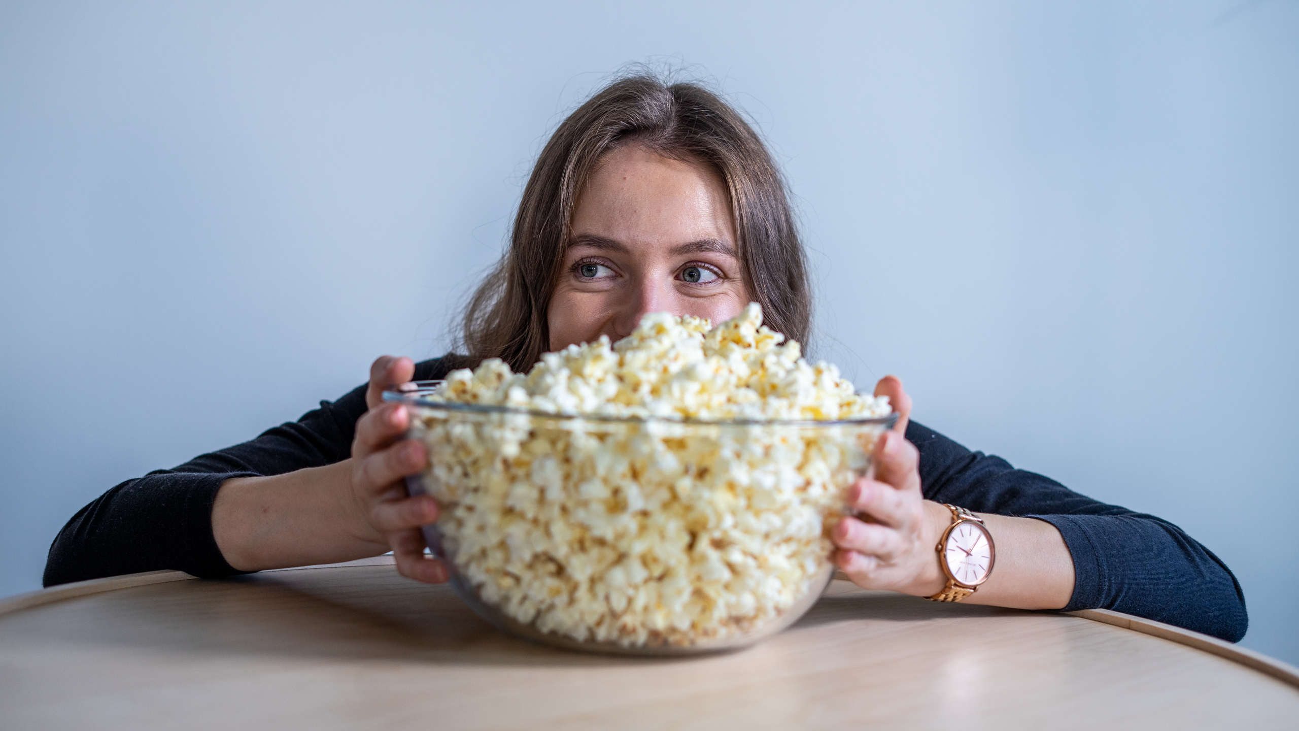 Žaneta, Sudolabs' recruiter, hiding behind a bowl of popcorn with a smile on her face