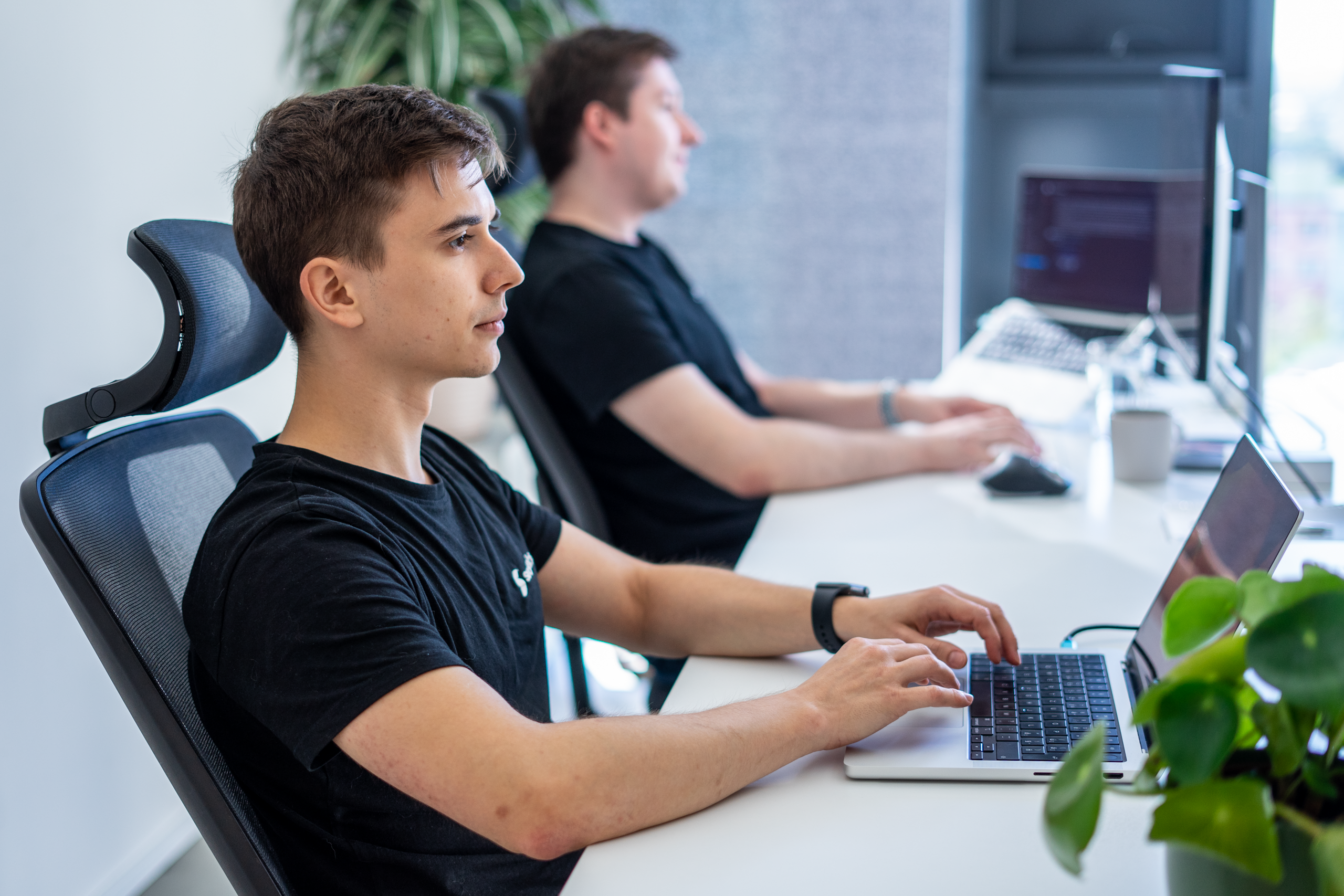 Erik Kandalík and Tomas Kuchárik, data scientists, collaborating at work. This image captures their teamwork and expertise in the field of AI and data science.