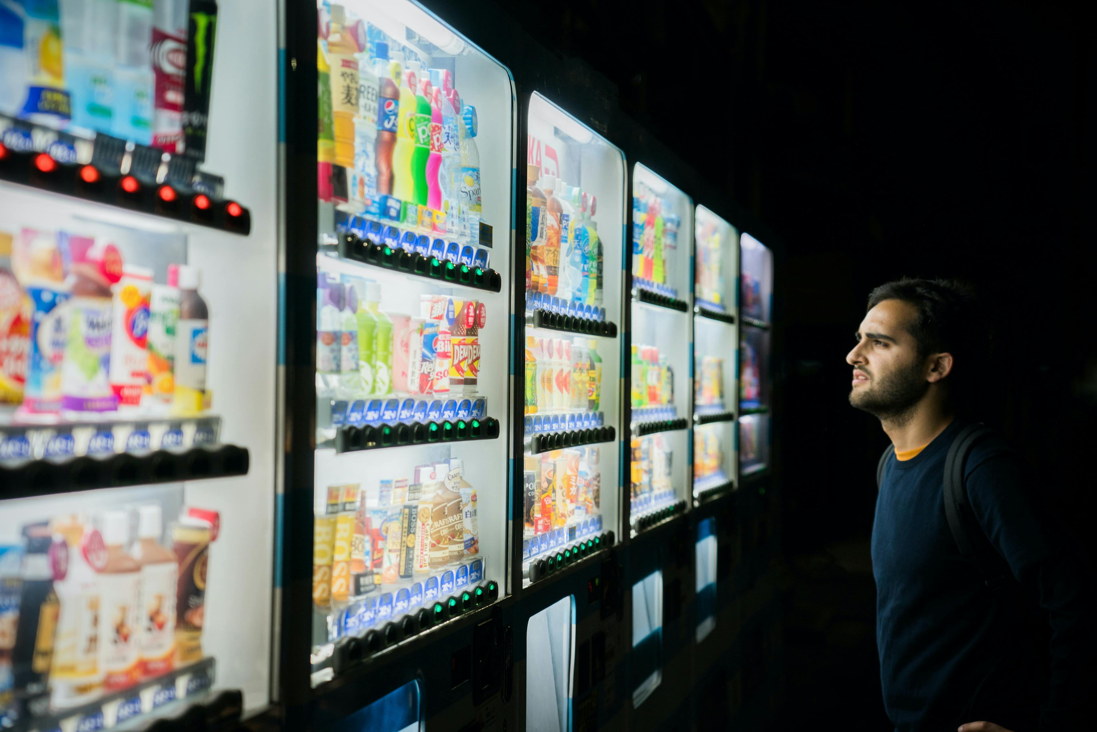 Confused guy looking at soda automat